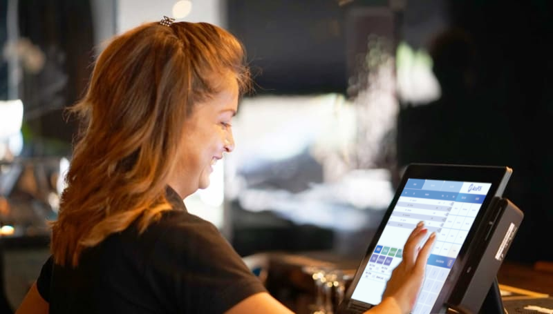 Bartender using AccuPOS on all-in-one point of sale hardware in bar